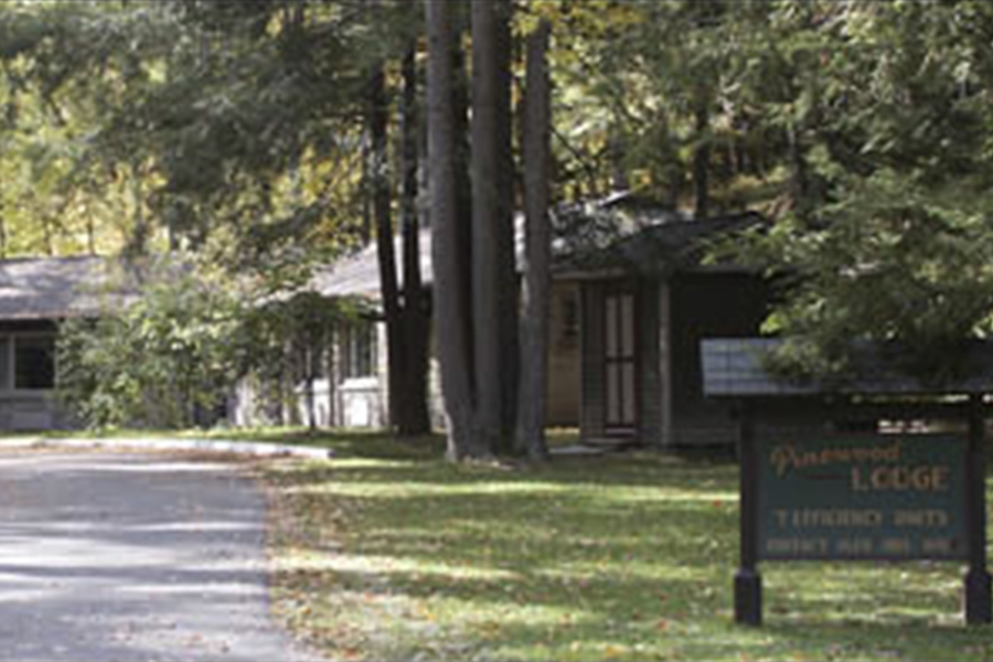 Pinewood Lodges exteriors with sign in foreground