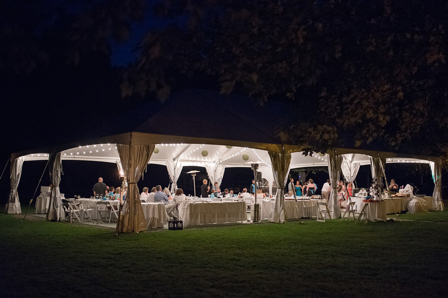 small wedding reception under the tent after dark